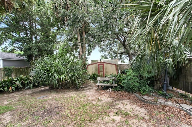 view of yard featuring an outdoor structure and a fenced backyard