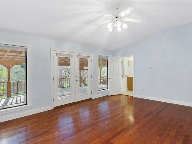 spare room featuring hardwood / wood-style floors, lofted ceiling, plenty of natural light, and french doors