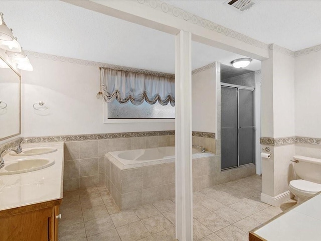 bathroom with visible vents, a stall shower, a sink, tile patterned flooring, and toilet