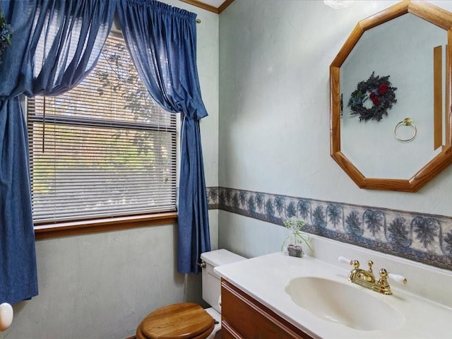 half bathroom featuring toilet and vanity