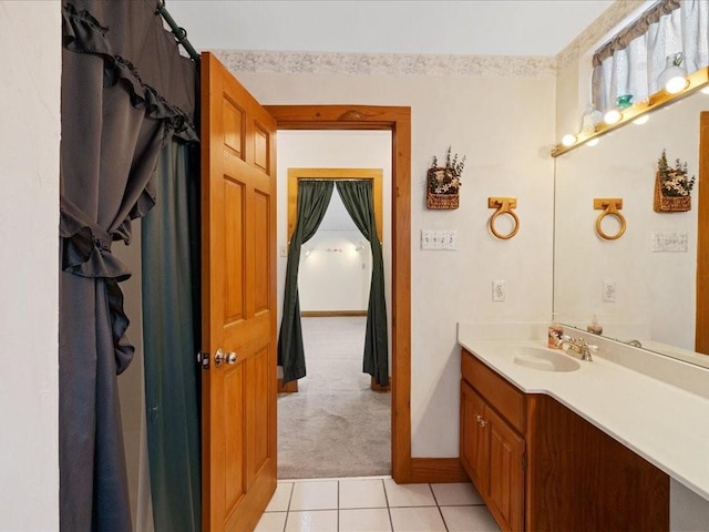 bathroom featuring baseboards, vanity, and tile patterned flooring