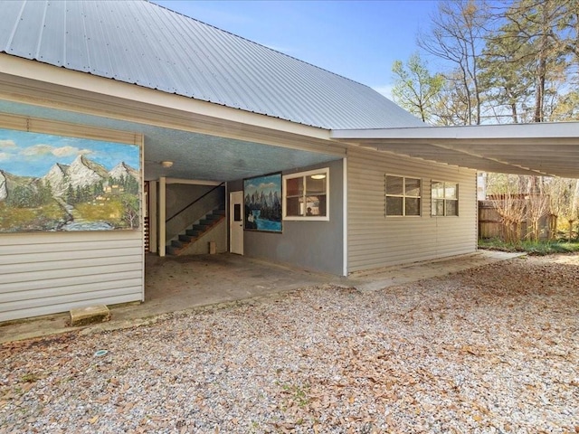 view of side of property with metal roof and an attached carport