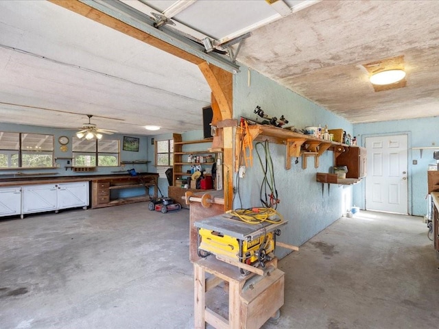 garage with a workshop area and a ceiling fan