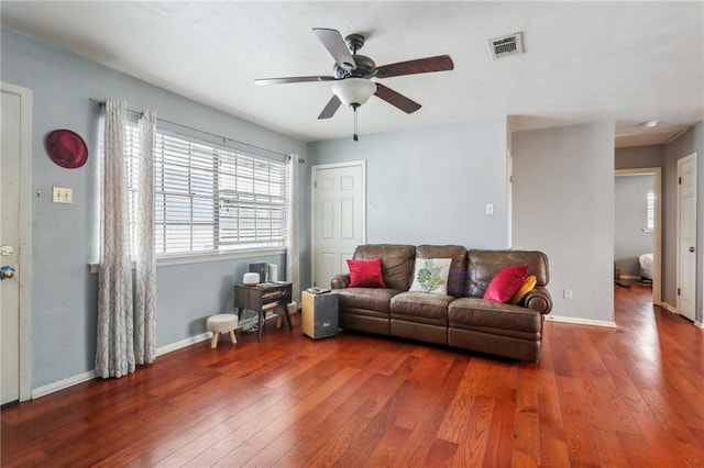 living room with wood-type flooring, ceiling fan, and baseboards