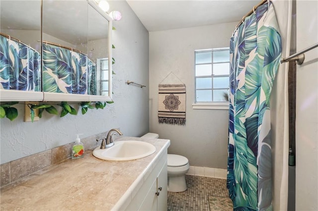 full bathroom with tile patterned flooring, toilet, vanity, and curtained shower