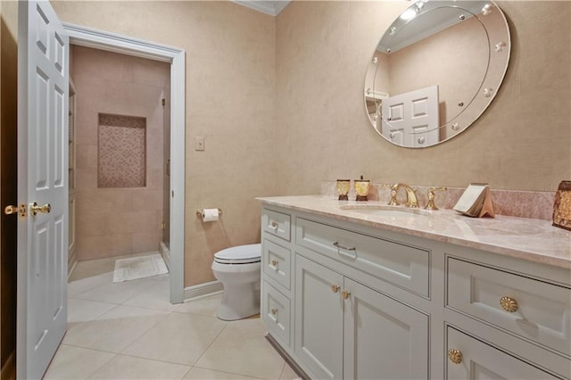 bathroom with vanity, tile patterned floors, toilet, and a stall shower