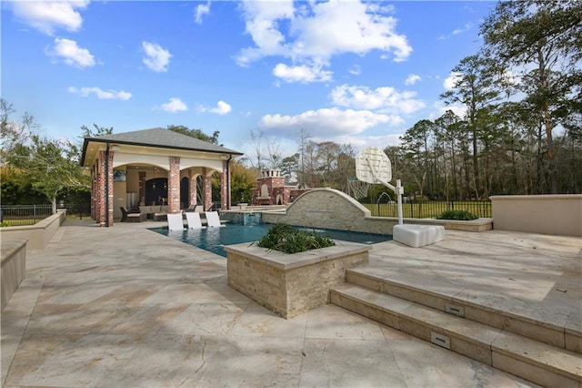 view of pool featuring a fireplace, a patio, and fence