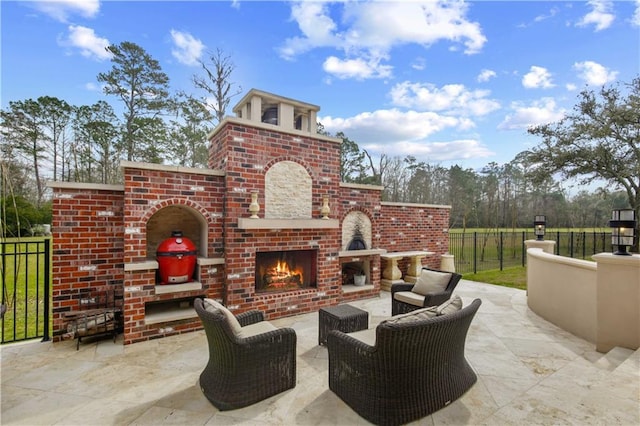 view of patio / terrace with an outdoor brick fireplace and fence