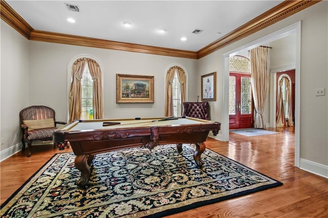 playroom featuring crown molding, wood finished floors, and visible vents