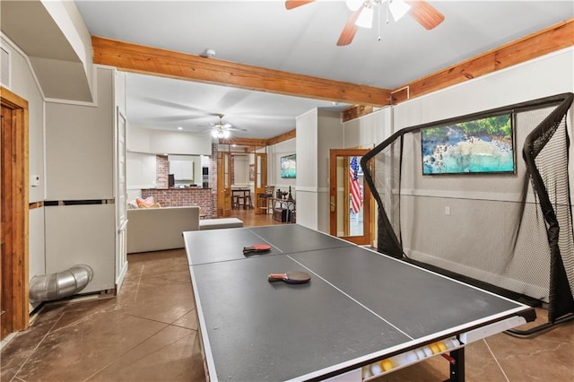 recreation room featuring beam ceiling and a ceiling fan