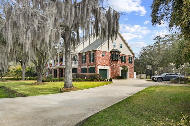 view of front of house with a garage, driveway, brick siding, and a front lawn