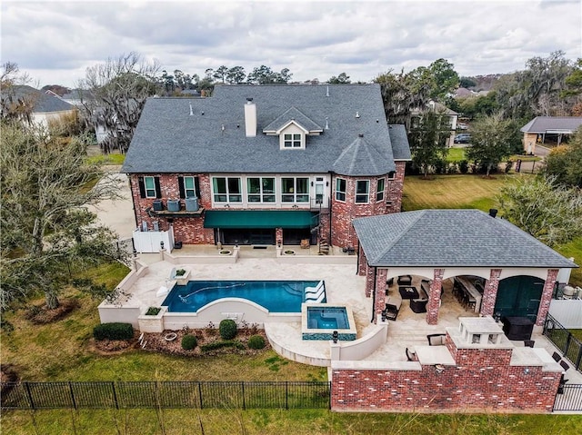 rear view of property featuring outdoor dry bar, stairway, a yard, a fenced backyard, and a patio