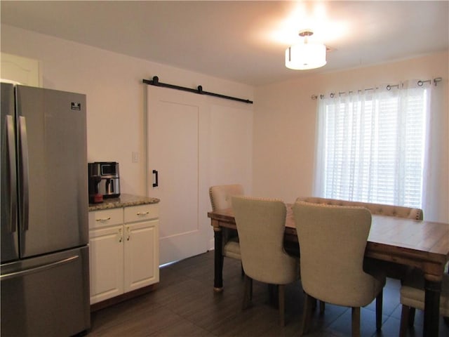 dining space featuring a barn door