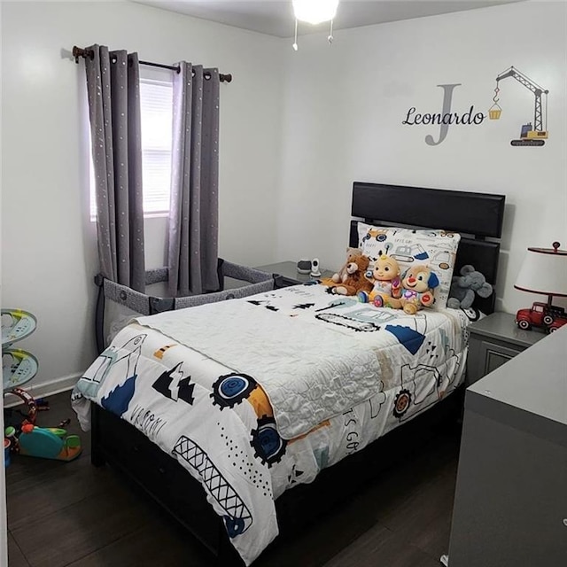 bedroom with dark wood-style flooring