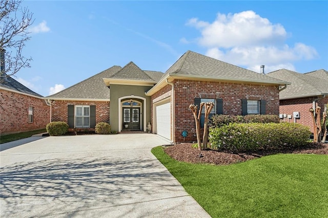 view of front of home with brick siding, driveway, a garage, and roof with shingles