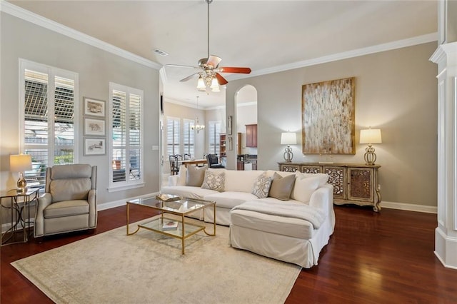 living area with visible vents, ornamental molding, a ceiling fan, wood finished floors, and baseboards