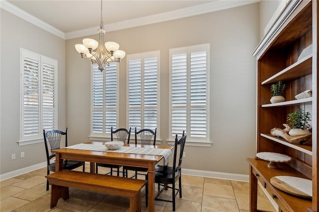 dining space featuring baseboards, an inviting chandelier, and crown molding