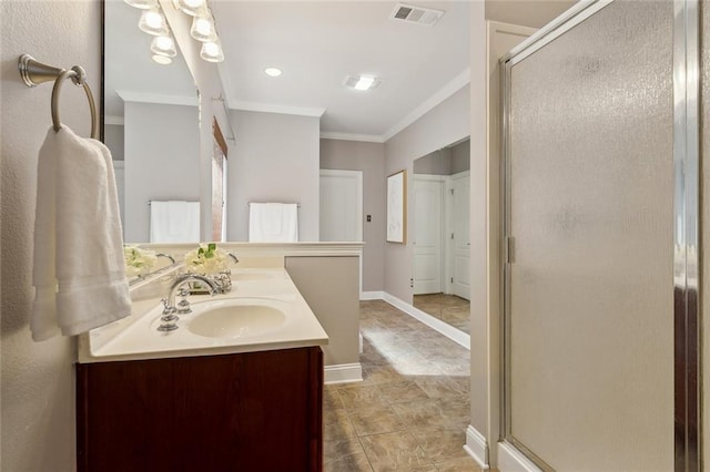 full bath with visible vents, double vanity, a stall shower, ornamental molding, and a sink