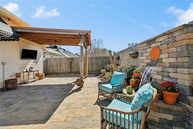 view of patio / terrace with a fenced backyard and ceiling fan