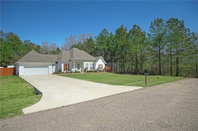 view of front of home with fence, driveway, an attached garage, stucco siding, and a front lawn