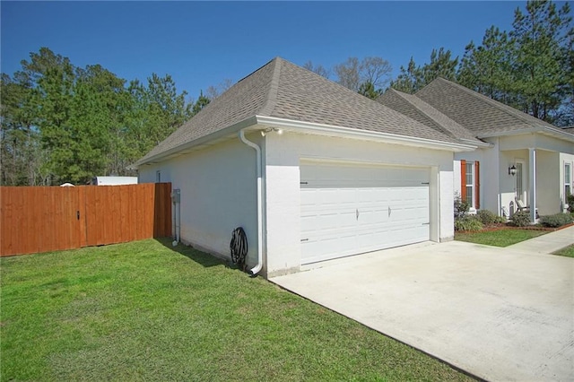 view of property exterior with fence, a yard, a shingled roof, stucco siding, and a garage