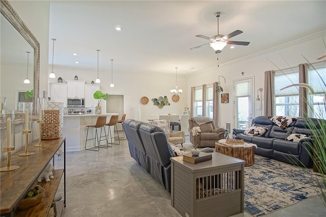 living area featuring recessed lighting, finished concrete flooring, crown molding, and ceiling fan with notable chandelier