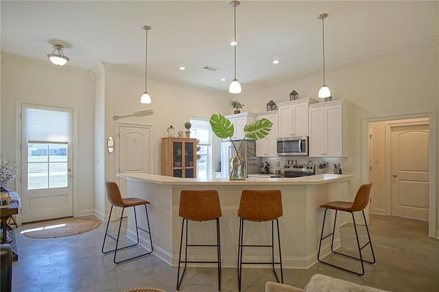 kitchen featuring stainless steel appliances, plenty of natural light, and a breakfast bar