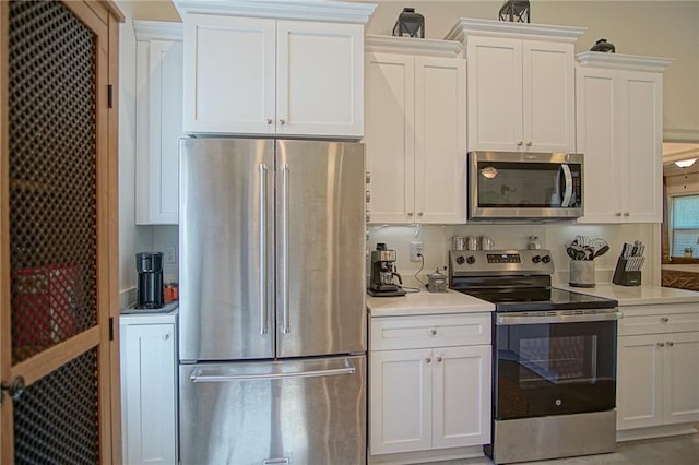 kitchen featuring light countertops, white cabinets, and appliances with stainless steel finishes