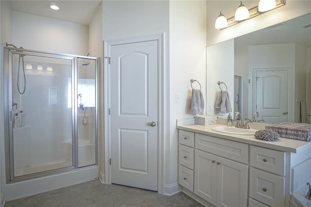 bathroom featuring vanity, recessed lighting, visible vents, and a stall shower