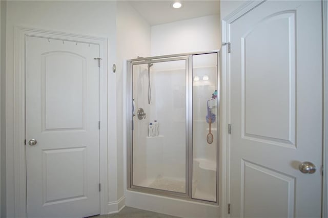 bathroom with a shower stall and recessed lighting