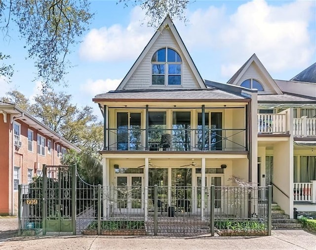 exterior space featuring a balcony, a gate, and fence