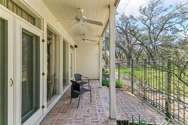 view of patio / terrace featuring a ceiling fan and fence