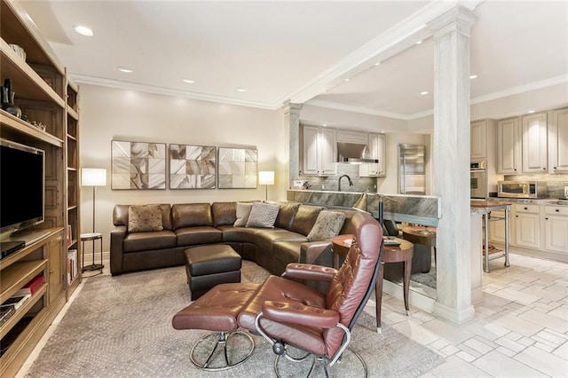 living area with recessed lighting, crown molding, and ornate columns