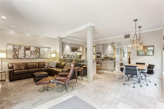 living room with visible vents, ornamental molding, recessed lighting, baseboards, and ornate columns