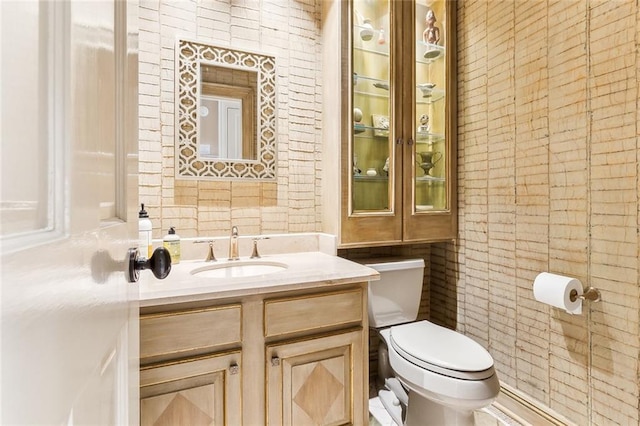 bathroom featuring vanity and toilet