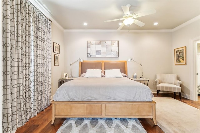 bedroom with recessed lighting, crown molding, baseboards, and wood finished floors