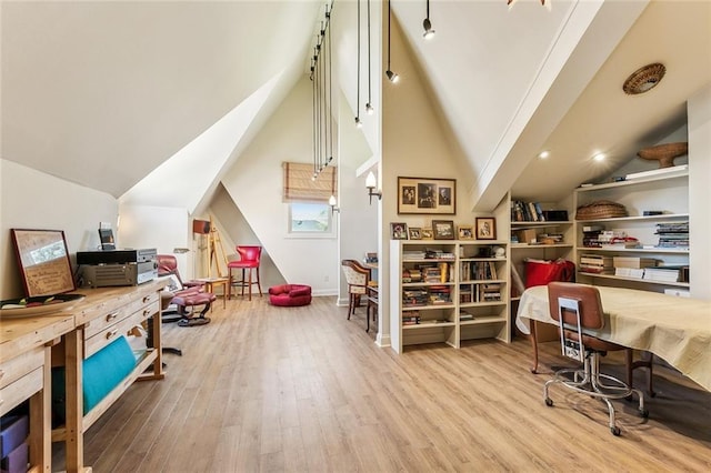 home office featuring baseboards, lofted ceiling, and wood finished floors