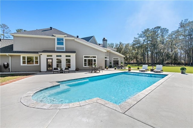 outdoor pool featuring a yard and a patio