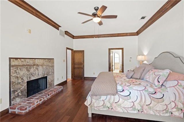 bedroom featuring crown molding, wood finished floors, visible vents, and baseboards