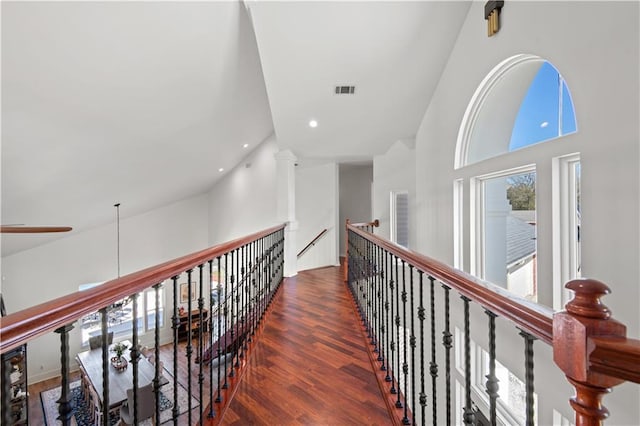 corridor with recessed lighting, visible vents, high vaulted ceiling, and wood finished floors