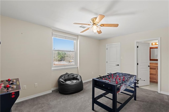 rec room featuring visible vents, baseboards, a ceiling fan, and carpet floors