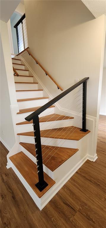 stairs with wood finished floors