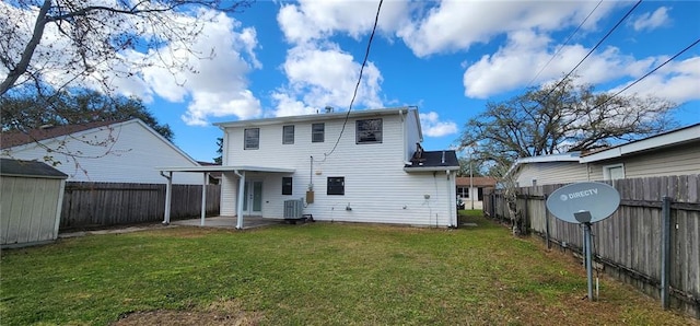 rear view of property with a patio area, a yard, a fenced backyard, and an outdoor structure