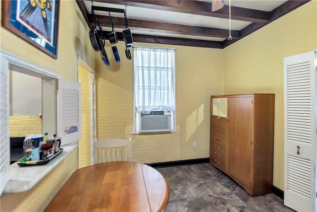 dining room with beam ceiling, cooling unit, and brick wall