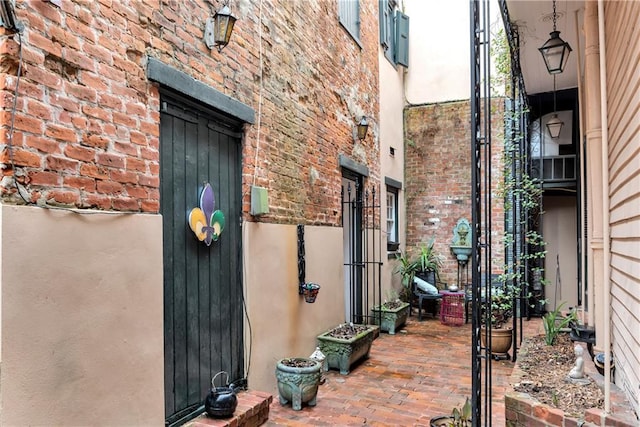 doorway to property featuring brick siding