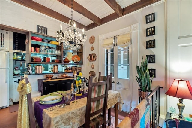 dining area with beamed ceiling and a chandelier