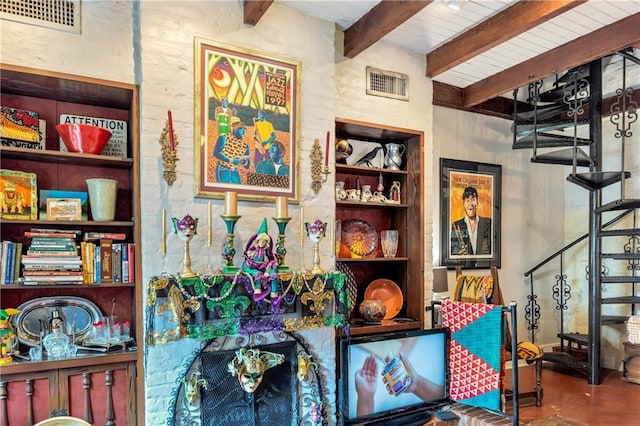 room details featuring beam ceiling, visible vents, built in shelves, and finished concrete floors