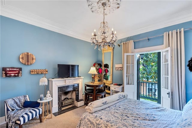 bedroom with ornamental molding, access to outside, carpet, an inviting chandelier, and a fireplace