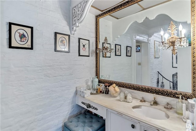 bathroom with a chandelier and vanity