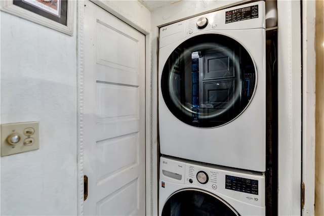 laundry area with laundry area and stacked washer and dryer